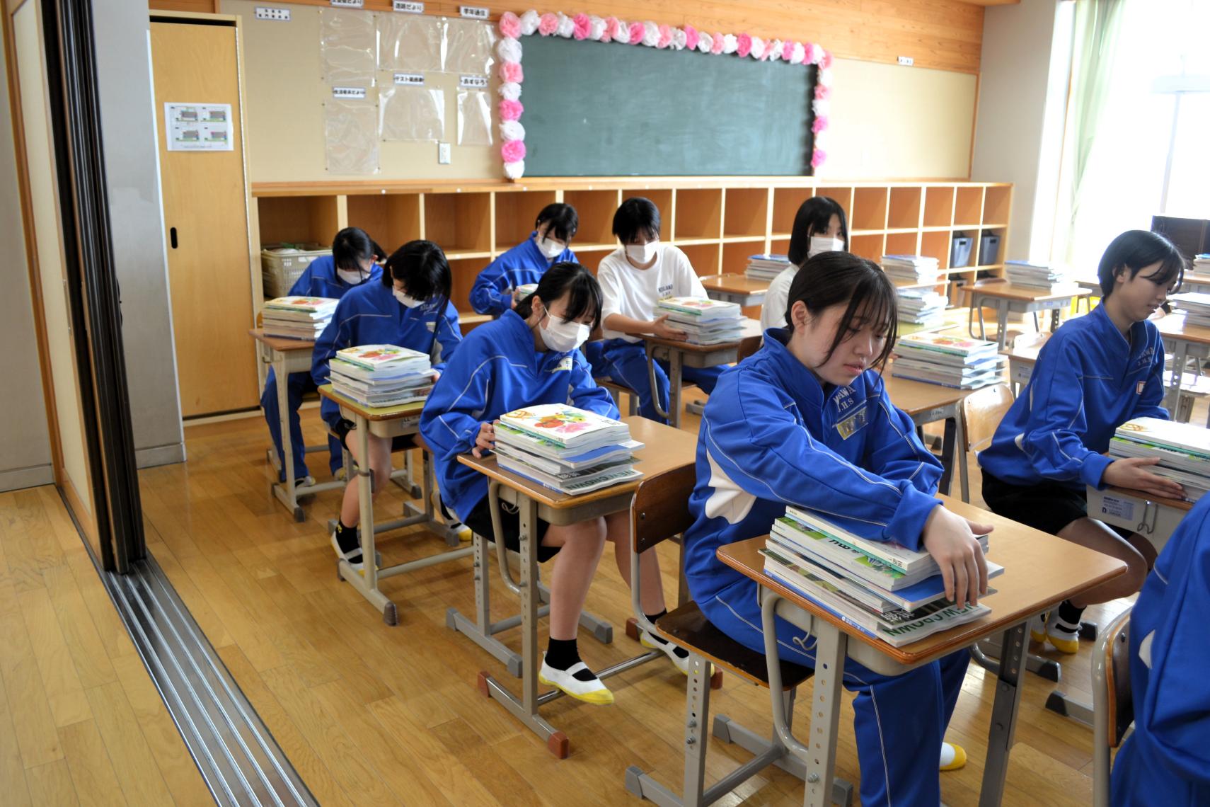 05 １年生教室で教科書をセットする２年生